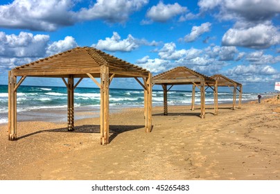 Sea shore and wooden sun shelters , Netanya, Israel