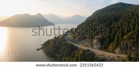 Sea to Sky Highway on Pacific Ocean West Coast. Aerial Panorama. Sunny Colorful Sunset. Located in Howe Sound between Vancouver and Squamish, British Columbia, Canada.