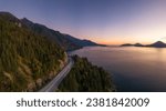 Sea to Sky Highway on West Coast of Pacific Ocean. Aerial Mountain Landscape. Twilight sky. Howe Sound, BC, Canada.
