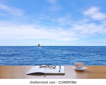 Sea, sky, white clouds and fishing boats.
Nature, with coffee cup, tablet, glasses, diary, book, pen And Writing notebook to record the memories of the holidays., in Thailand.