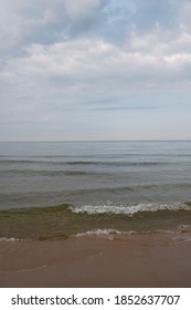 The Sea With Small Waves On A Cloudy Beach Day