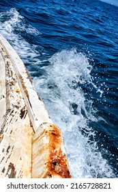 Sea Splashing By The Waves Generated By Crashing The Wooden Hull Of A Small Fishing Boat Against The Water