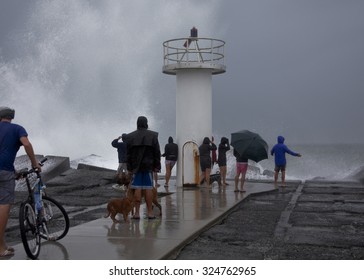 Sea sprayed high in air as waves crash into the coast during a storm in Queensland, Australia. climate change, sea level rise, global warming, freak weather, super storms.