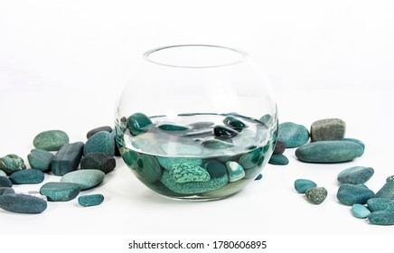 Sea Stones Turquoise In Water In A Glass Vase On A White Background