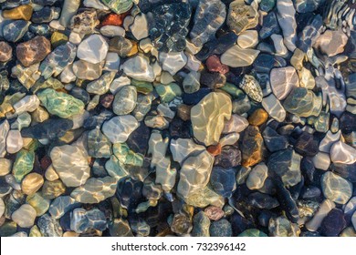 Sea stones in the sea water. Pebbles under water. The view from the top. Nautical background. Clean sea water. Transparent sea. - Powered by Shutterstock