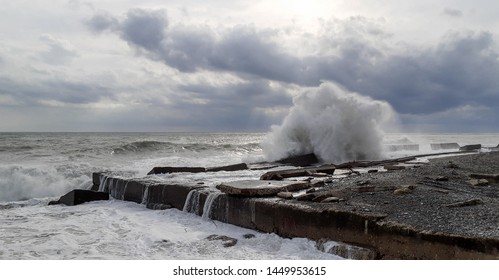 Sea Strorm, A Big Wave Crashing Against The Rocks On The Shore