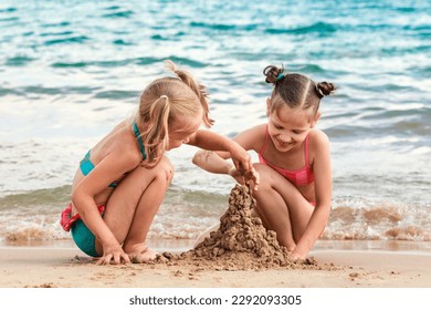 Sea Summer Fun Vacation. Happy Children building Sand castle, playing on Sea Beach. Sandy Beach for Kids.  - Powered by Shutterstock