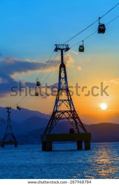 Sea sunset the cable car over sea leading to\
Vinpearl Park, Nha Trang,\
Vietnam.