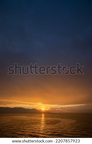 Sea, sunset, mountain view and a cloudy weather.
