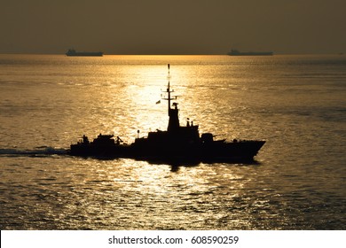 Sea Sunset And Silhouette Of Navy Ship