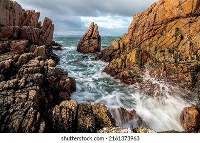 Sea surf at the coastal rocks. Rocky beach sea surf. Crashing sea waves at rocks. Sea surf at rocks - Shutterstock ID 2161373963