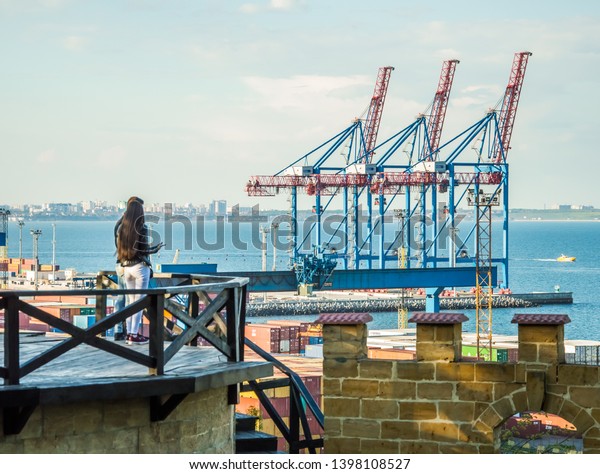 Sea Trade Port, Odessa\
City, Ukraine, May 2019. Container terminal. Cranes, cargo ships.\
Horizon.  