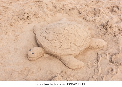 Sea Turtle Sand Sculpture On The Beach