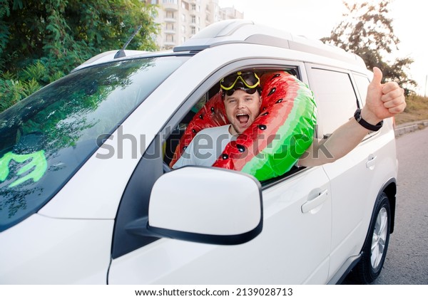sea vacation car travel concept happy man in\
scuba mask driving car full of\
bags