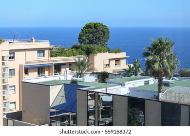 sea view apartment house on Mediterranean coast, flat roofs and green bush on them