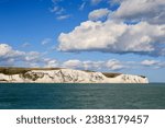 Sea view of the famous white cliffs near Dover in UK from a ferry leaving France toward Great Britain. 