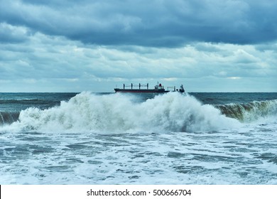 Sea View. Panorama Of Sea And Sky. The Storm And The Storm Clouds On The Sea. Big Waves.  Lonely Cargo Ship In The Distance