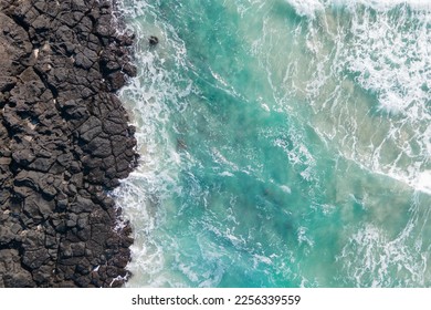 Sea and volcanic rocks close-up aerial view, natural background. - Shutterstock ID 2256339559