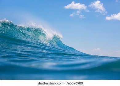 Sea Water Background. Big Blue Ocean Powerful Wave Crashing Against Blue Sky, Closeup View From Water Level, Extreme Photo