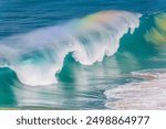 Sea water rainbows in the waves at Whale Beach in the Northern Beaches region of Sydney, NSW, Australia.