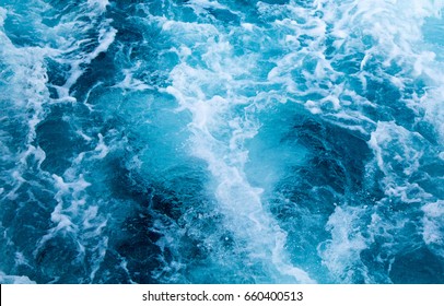 Sea water ship trail with white foamy wave. Tropical islands ferry travel. Cruise liner seawater trail. Blue ocean top view. Big ship pitching image. White water wave in the sea. Exotic island hopping