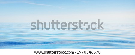 Sea water texture. Clear blue sky with white clouds and plane tracks. Reflections on water. Baltic sea, Estonia