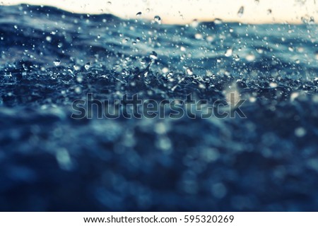 sea wave close up at sunset in the rain, low angle view