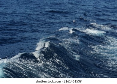 Sea wave on the Mediterranean Sea. There is splashed water on the crest of waves. On the crest of the wave there are water drops. Copy space is available. Suitable as background, abstract and texture.