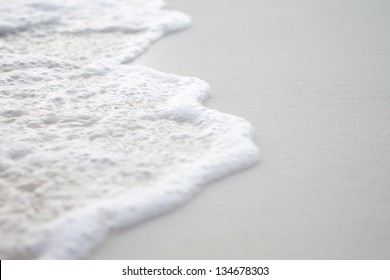 Sea wave on white sand.