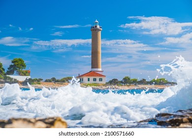 Sea waves breaking on rocks of lighthouse of Veli Rat on the island of Dugi Otok, Croatia