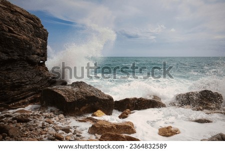 The sea waves crash against the rocky shores of the Sutomore coast
