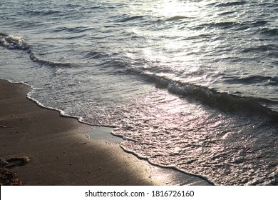 sea waves crashing on the shore at sunset - Powered by Shutterstock