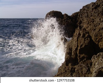 Sea waves crushing violently on a rocky shore