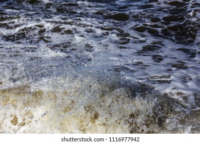 Sea waves during a storm. Heavy deep sea waves with white foam on the crests of the peaks, background marine photo of a dark storm