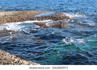 sea waves hitting the rocks on the shore