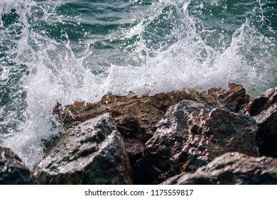 Sea waves are splashing against the hard rocks at the beach of Koh Phangan. Close up of waves splashing against rocks. Sea Photography.
 - Powered by Shutterstock