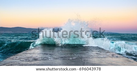 Sea waves in sunset with rocks and stones. Nature landscape.