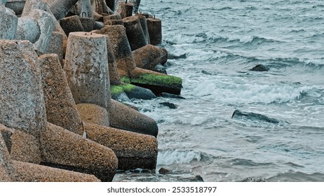 Sea Waves Water Splashing on Heavy Concrete Tetrapod Coastal Defense Structure Seawall Embankment - Powered by Shutterstock