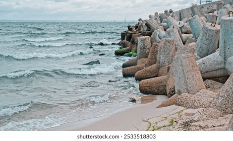 Sea Waves Water Splashing on Heavy Concrete Tetrapod Coastal Defense Structure Seawall Embankment - Powered by Shutterstock