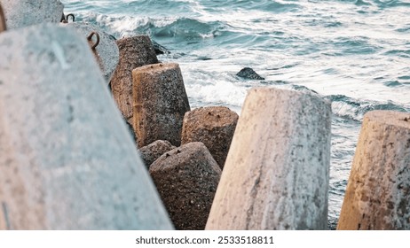 Sea Waves Water Splashing on Heavy Concrete Tetrapod Coastal Defense Structure Seawall Embankment - Powered by Shutterstock