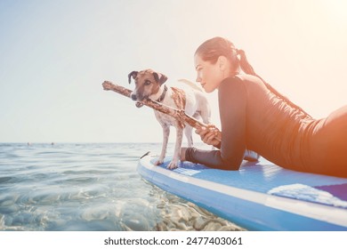 Sea woman sup. Silhouette of happy positive young woman with her dog, surfing on SUP board through calm water surface. Idyllic sunset. Active lifestyle at sea or river. Summer vacation with pets. - Powered by Shutterstock