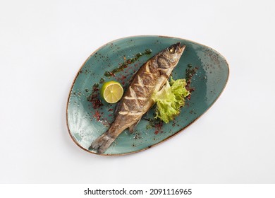 Seabass Grill In A Plate. On White Background. View From Above.