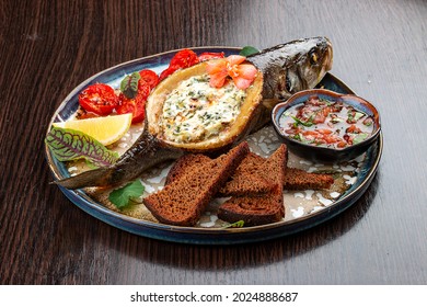 Seabass With Spinach And Cream Sauce. On A Wooden Background