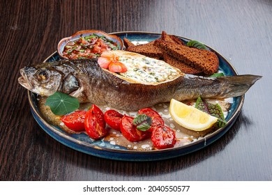 Seabass With Spinach And Cream Sauce. On A Wooden Background