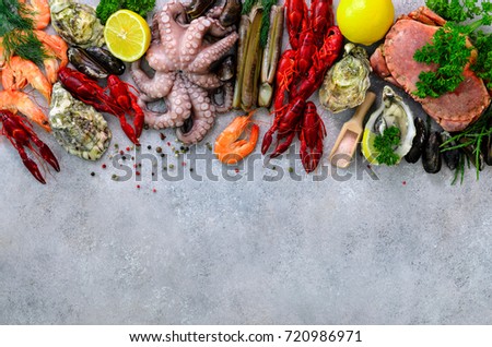 Seafood background - fresh mussels, molluscs, oysters, octopus, razor shells, shrimps, crab, crawfish, crayfish, seaweed, lemon, spices. Banner with copyspace