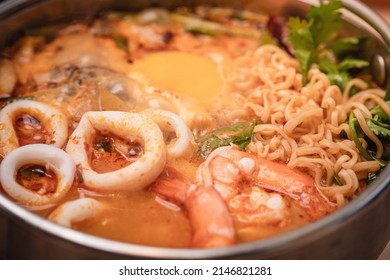 Seafood Budae Jjigae. Spicy instant noodle hot pot with shrimp, squid, pickled egg and more. Popular Korean food.