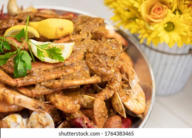 Seafood Cajun Tray With Yellow Flowers. Restaurant Menu. Hot And Spicy Food. King Crab  Legs Cajun.