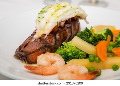 A Seafood Dinner Of Lobster Tail, Shrimp And Vegetables