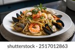 Seafood Linguine: Delicate linguine pasta tossed with a medley of fresh seafood, including shrimp, clams, and mussels, in a light white wine and garlic sauce with a hint of chili.