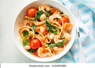 Seafood Linguine With Prawns, Scallops And Salmon, Spinach And Tomatoes